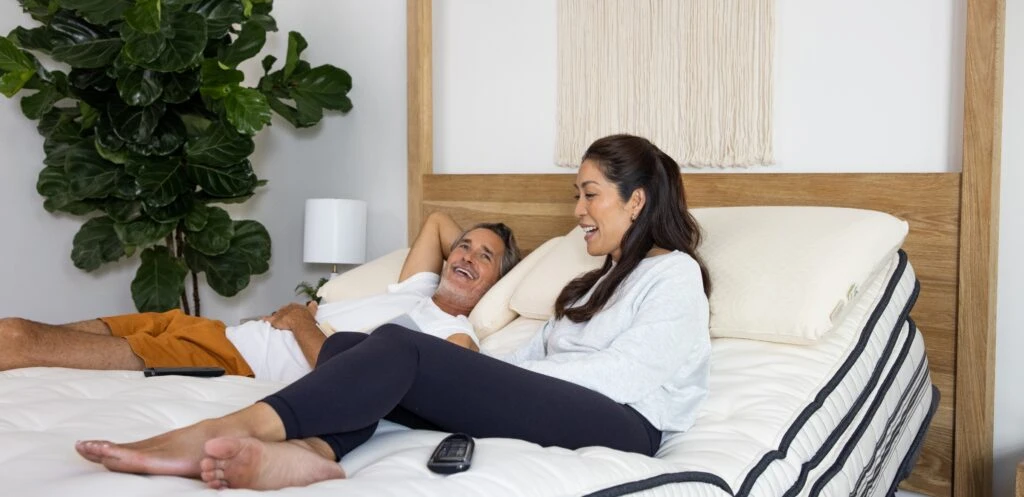 couple laying comfortably on bed