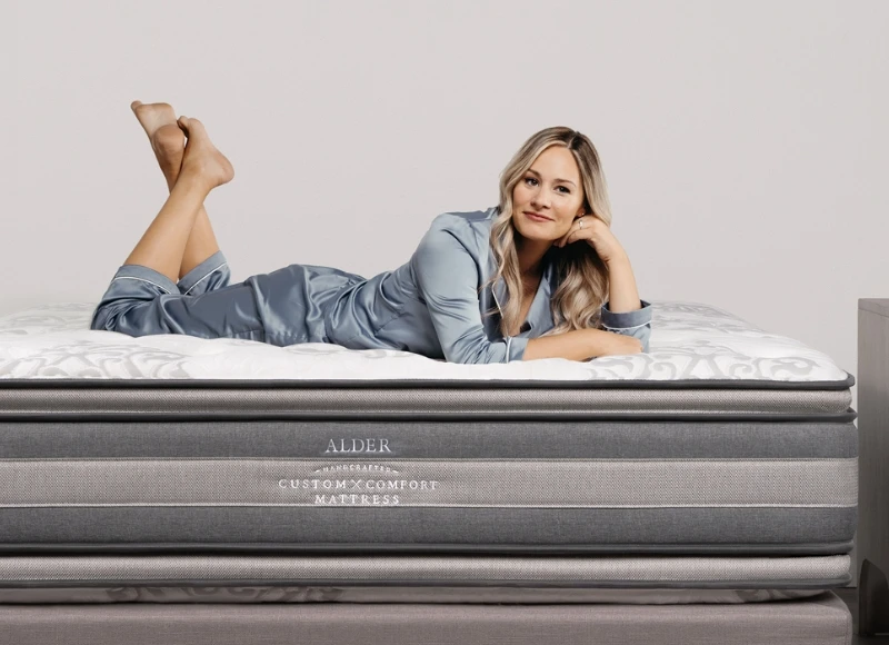 woman relaxing on handcrafted dual-sided Custom Comfort mattress designed for hip pain relief